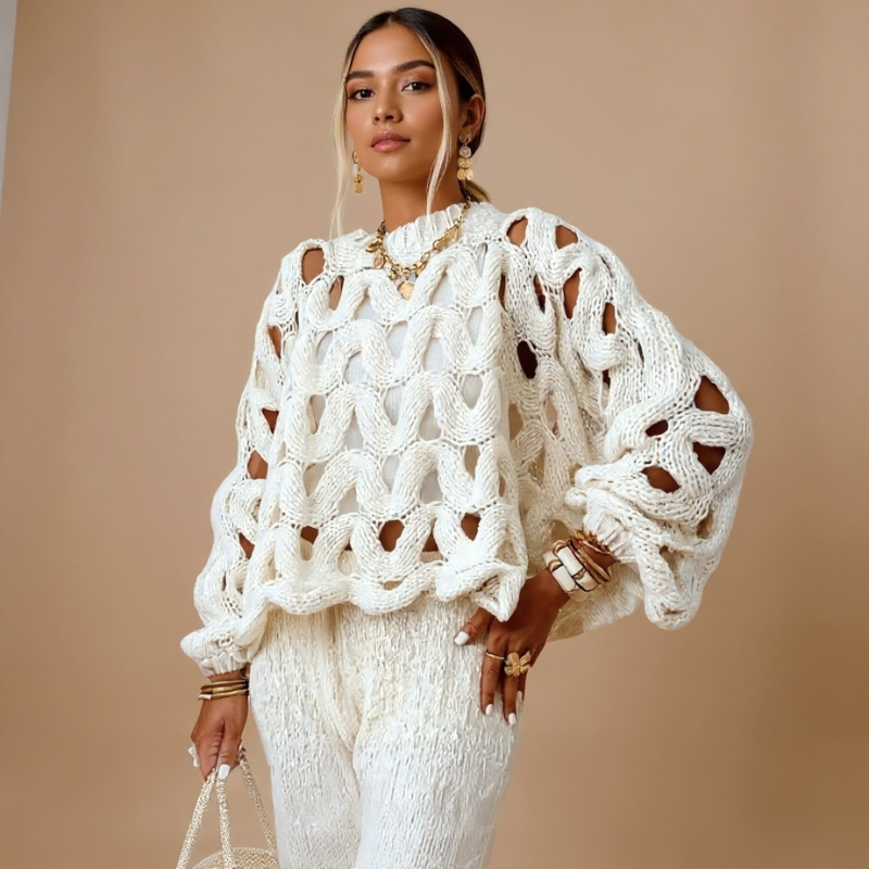 Woman wearing a white crochet sweater against a beige background