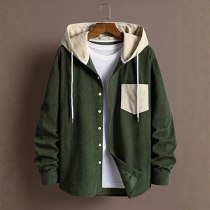 Green jacket with beige hood and pocket on a hanger against a brown background