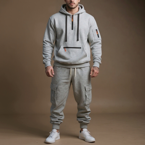 Person wearing a gray hoodie and cargo jogger pants on a brown background
