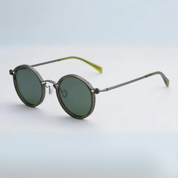 Round sunglasses with green lenses and black frames on a light blue background