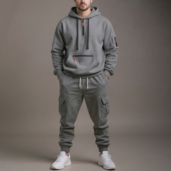 Person wearing a gray hoodie and cargo pants on a plain background