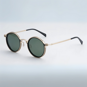 Round sunglasses with gold frame and dark lenses on a light gradient background