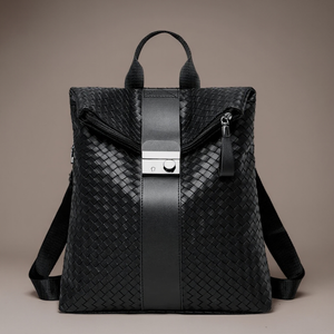 Black woven backpack with a silver buckle on a beige background