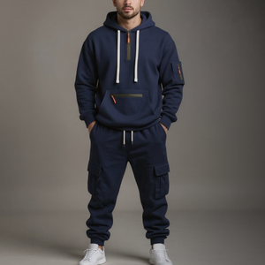 Person wearing a navy blue tracksuit with white accents on a gray background