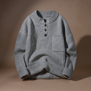 Gray knitted sweater with button details on a brown background