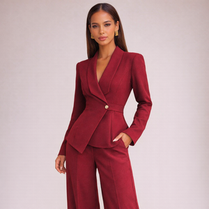 Woman wearing a red suit against a plain background