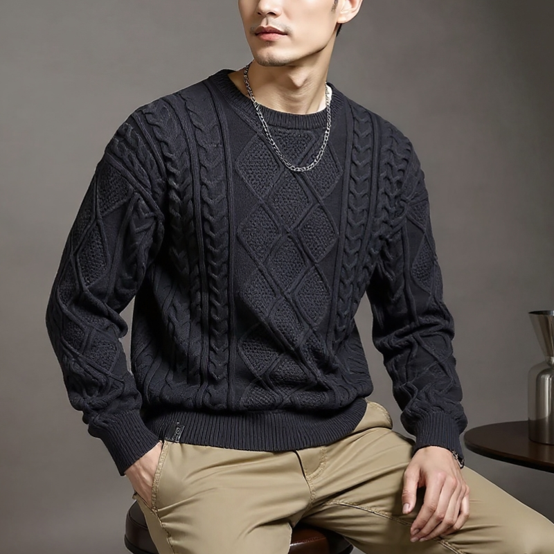 Person wearing a dark gray cable knit sweater against a brown background