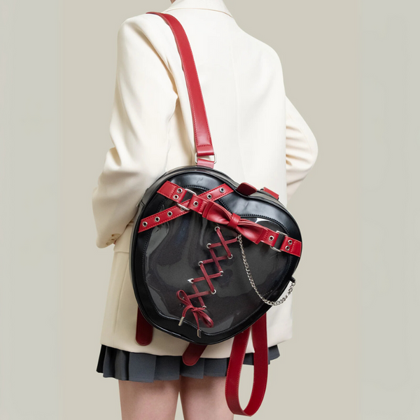 Person wearing a black backpack with red straps on a plain background