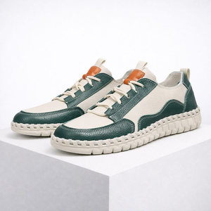 Pair of green and white sneakers on a white background