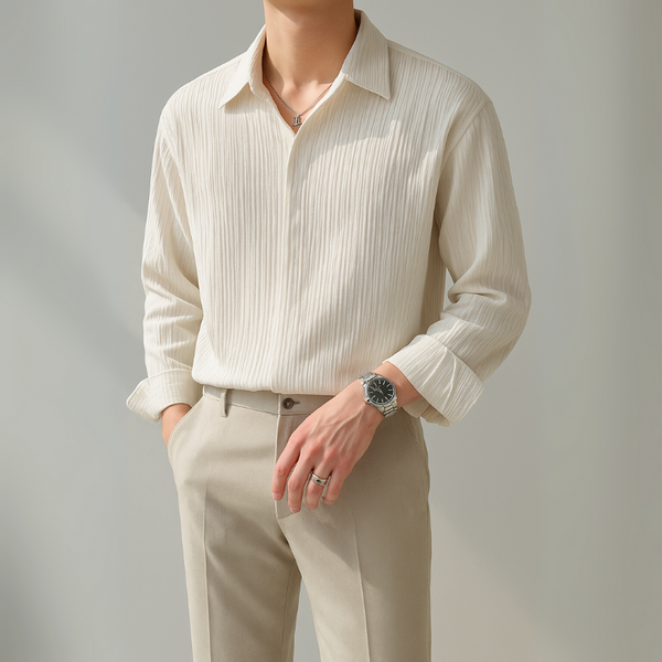 Person wearing a beige striped shirt and pants against a plain background