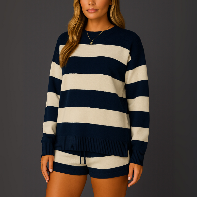 Person wearing a navy and white striped sweater and shorts on a gray background