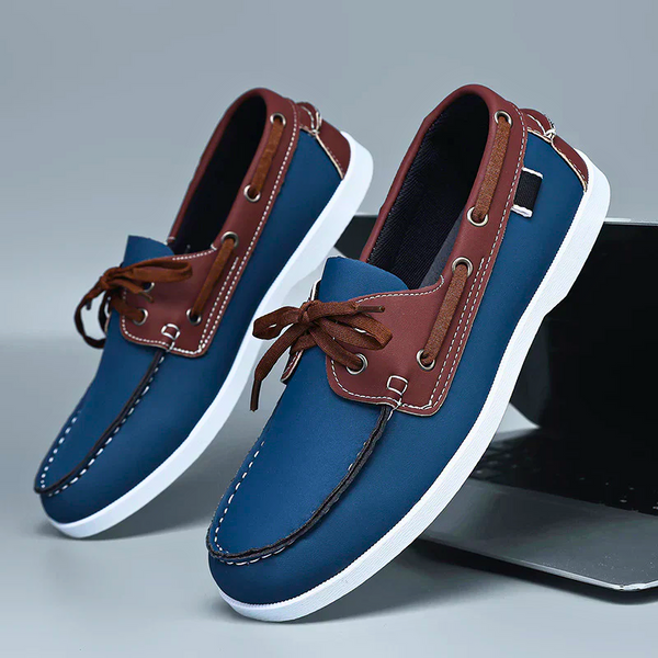 Blue and brown loafers on a gray background