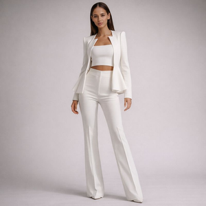 Woman wearing a white outfit on a plain background