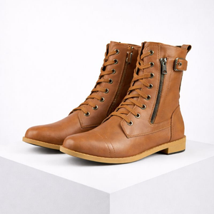 Pair of brown leather boots with zippers on a white background