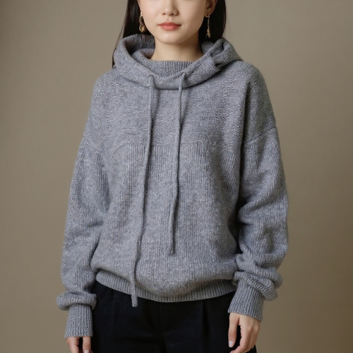Person wearing a gray hoodie against a brown background