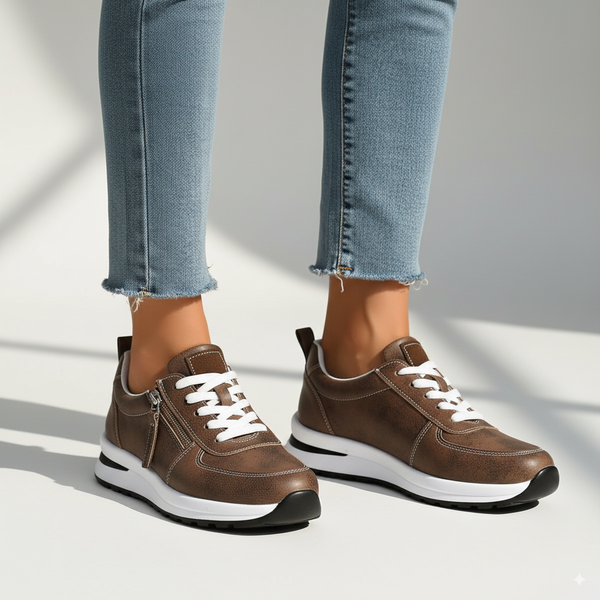 Brown sneakers with white laces on a light gray background