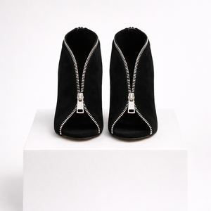 Black high-heeled shoes with zippers on a white background