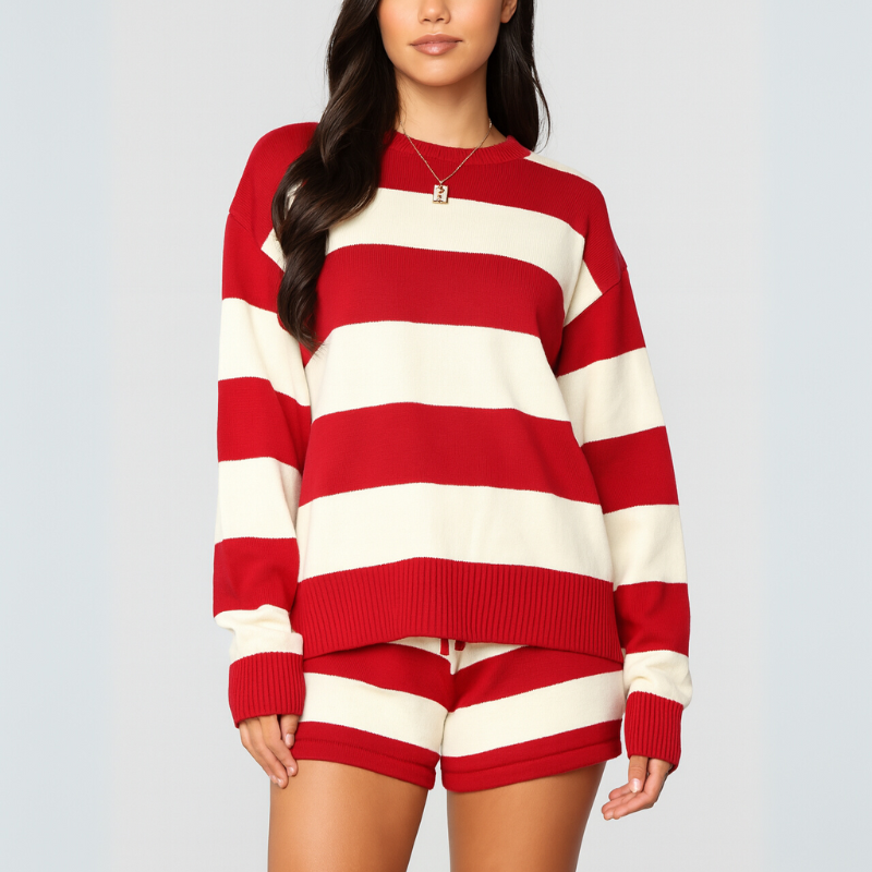 Person wearing a navy and white striped sweater and shorts on a gray background