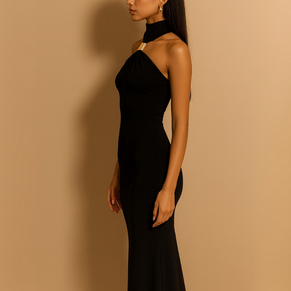 Woman wearing a black halter neck dress against a beige background