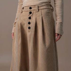 Beige corduroy skirt with button details on a neutral background