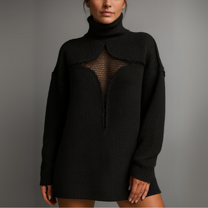 Black knit dress with mesh panel on a gray background
