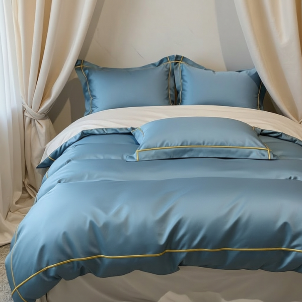 Blue bedspread with gold trim on a bed in a bedroom setting