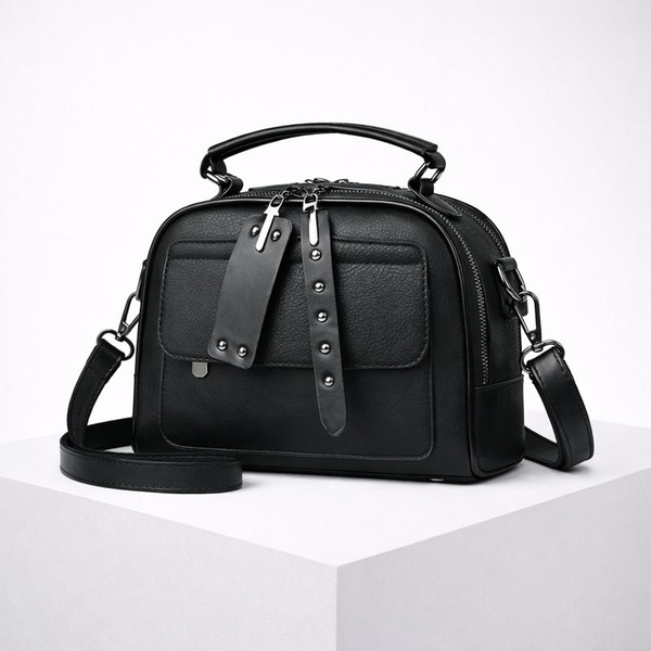 Black handbag with studded details on a white background