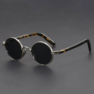 Round sunglasses with tortoiseshell frame on a dark gray background