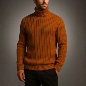 Man wearing a brown ribbed sweater against a gray background