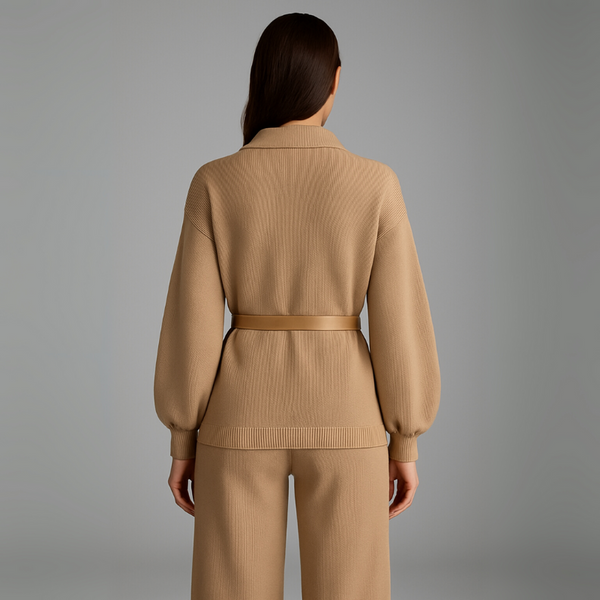 Woman wearing a beige ribbed knit outfit on a gray background
