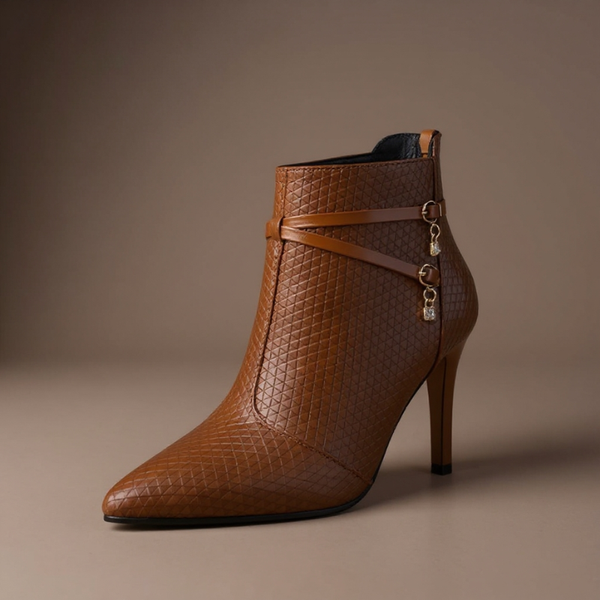 Brown high-heeled ankle boot with strap on a brown background