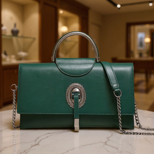 Green handbag with chain strap on a marble surface