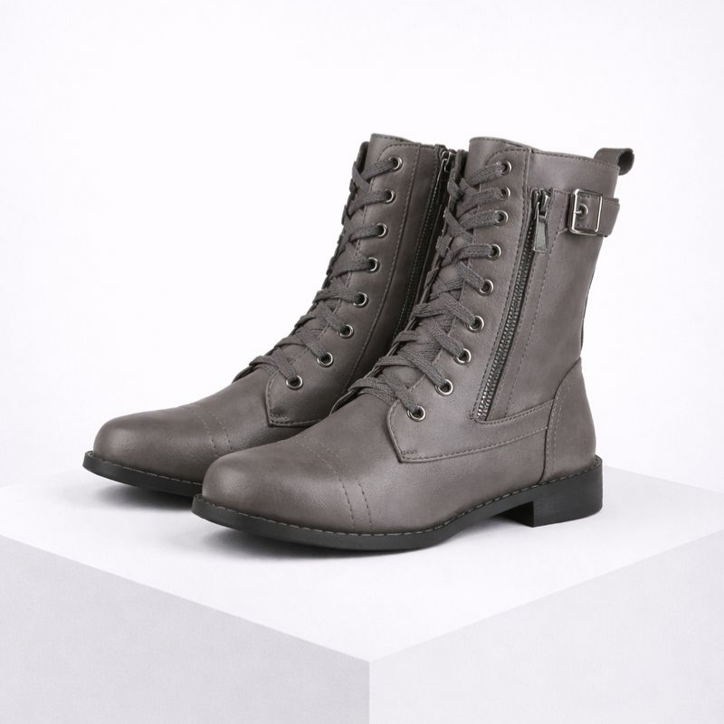 Pair of brown leather boots with zippers on a white background