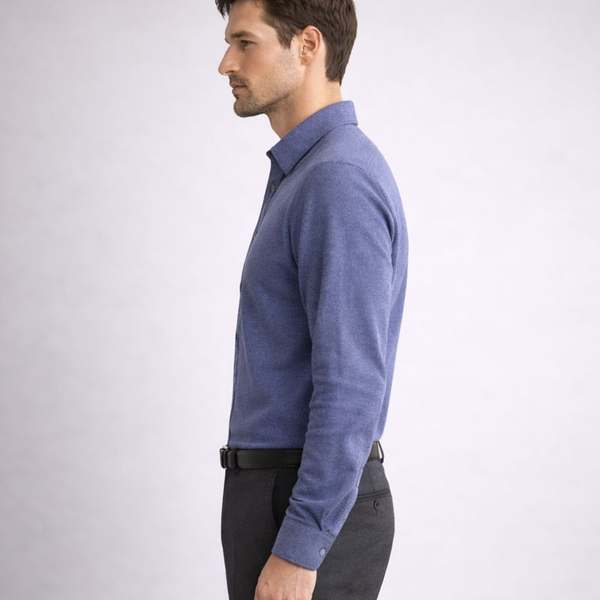 Man wearing a blue sweater and black pants on a white background