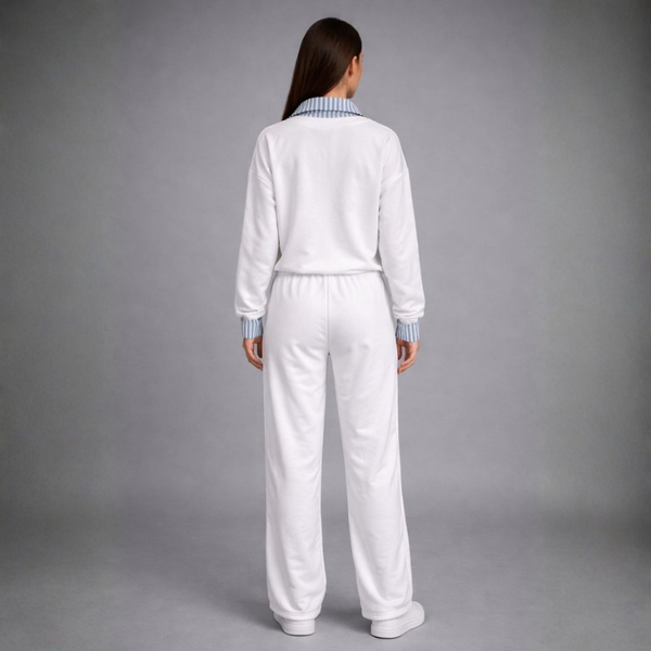 Person wearing a white tracksuit on a gray background