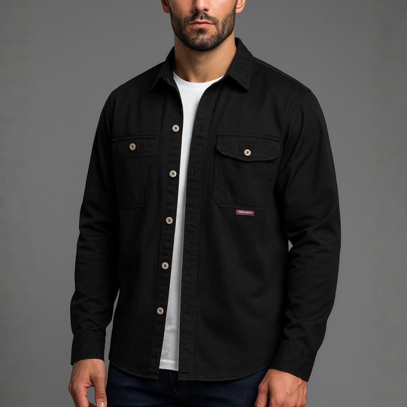 Man wearing a black shirt over a white shirt on a gray background