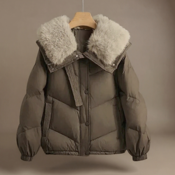 Brown puffer jacket with fur-lined hood on a mannequin against a beige background