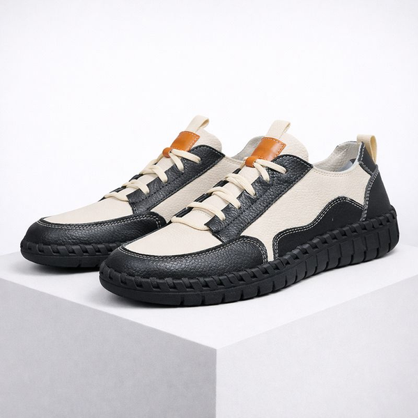 Black and white sneakers with brown accents on a white background