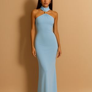 Woman wearing a light blue halter neck gown against a beige background