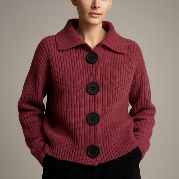 Red knitted cardigan with black buttons on a neutral background