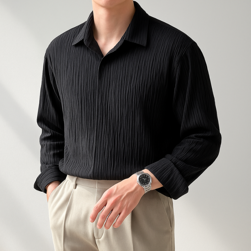 Person wearing a black ribbed shirt and beige pants against a light gray background