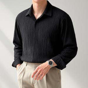 Person wearing a black ribbed shirt and beige pants against a light gray background