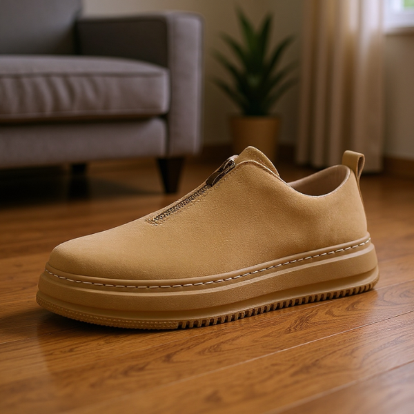 Beige slip-on shoe on a wooden floor with a blurred background