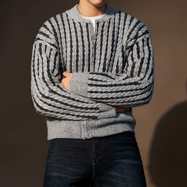 Person wearing a gray and black striped sweater against a brown background