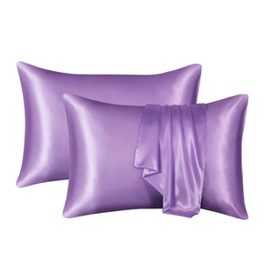 Two purple satin pillowcases on a white background