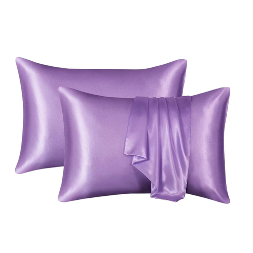 Two purple satin pillowcases on a white background