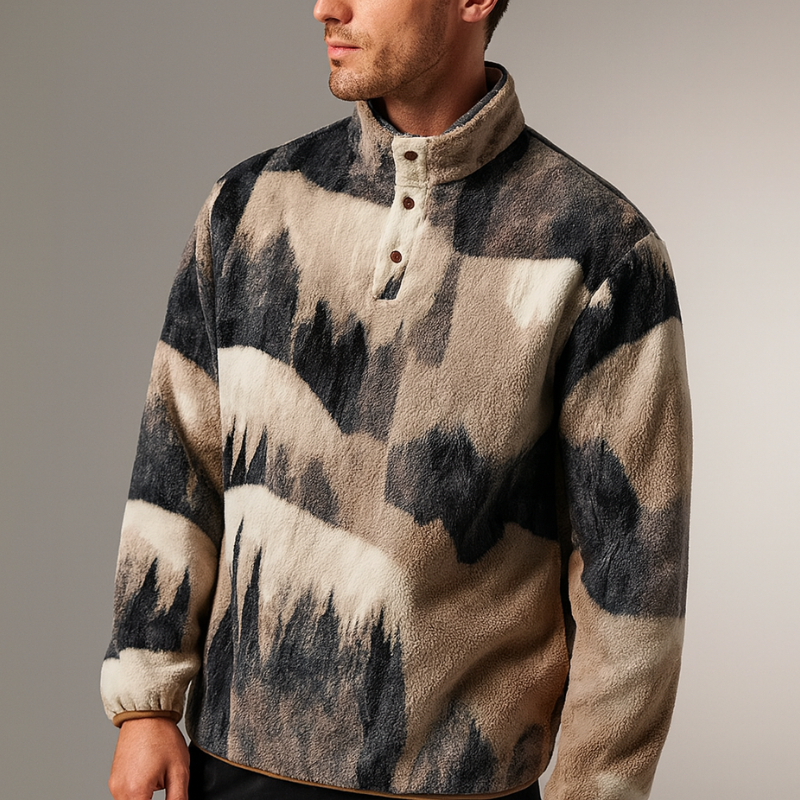 Person wearing a colorful patterned sweater against a gray background