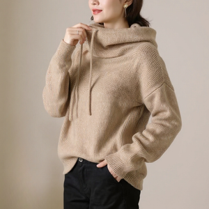 Beige hoodie worn by a person against a plain background