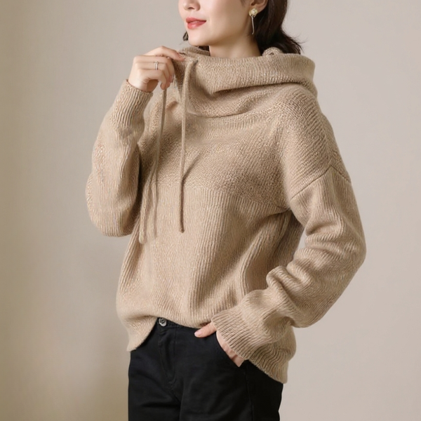 Beige hoodie worn by a person against a plain background