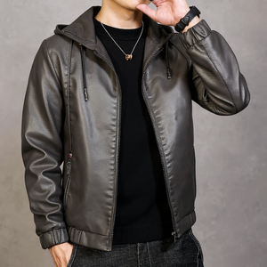 Person wearing a brown leather jacket against a gray background